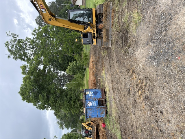 Excavator staged at an Arkansas demolition job